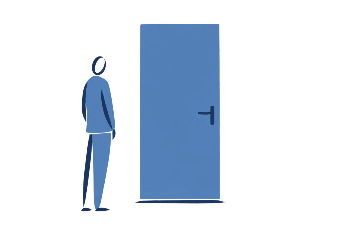 A person stands beside a closed door.