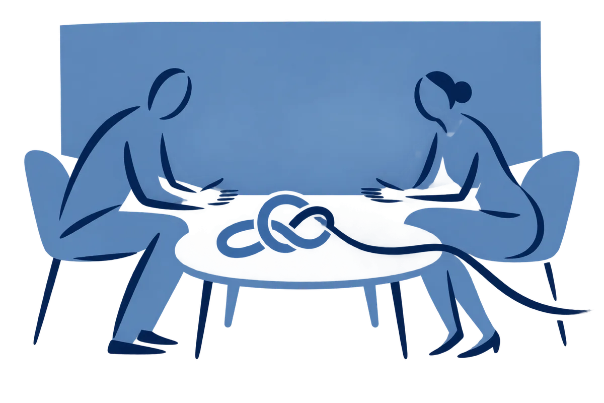 Two people at a small table, a knot between them coming loose at one end.