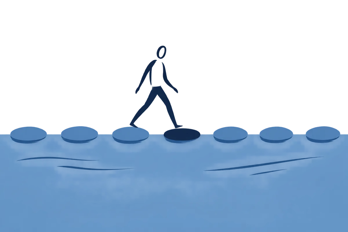 A person mid-stride across a row of stepping stones over water.