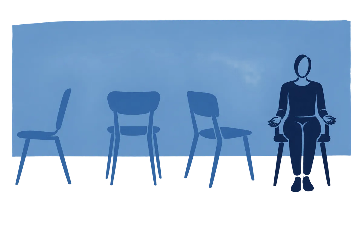 Four chairs in a row, each turned a different way, one person seated in the one that faces us.